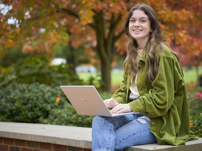 student typing on computer