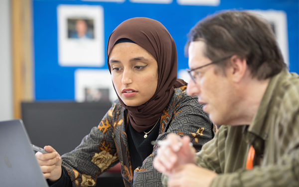 student and advisor on computer