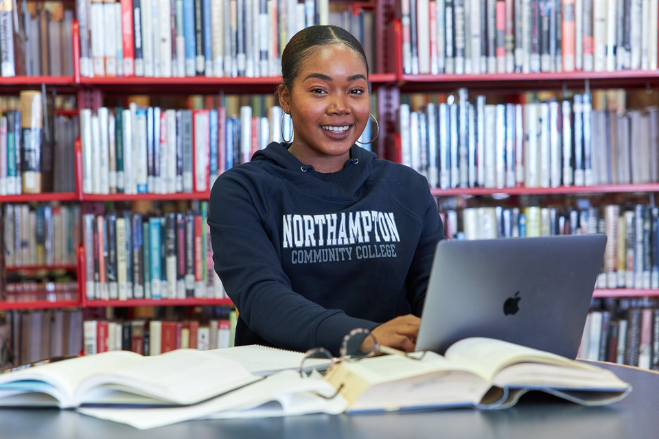 Black female student sitting in library