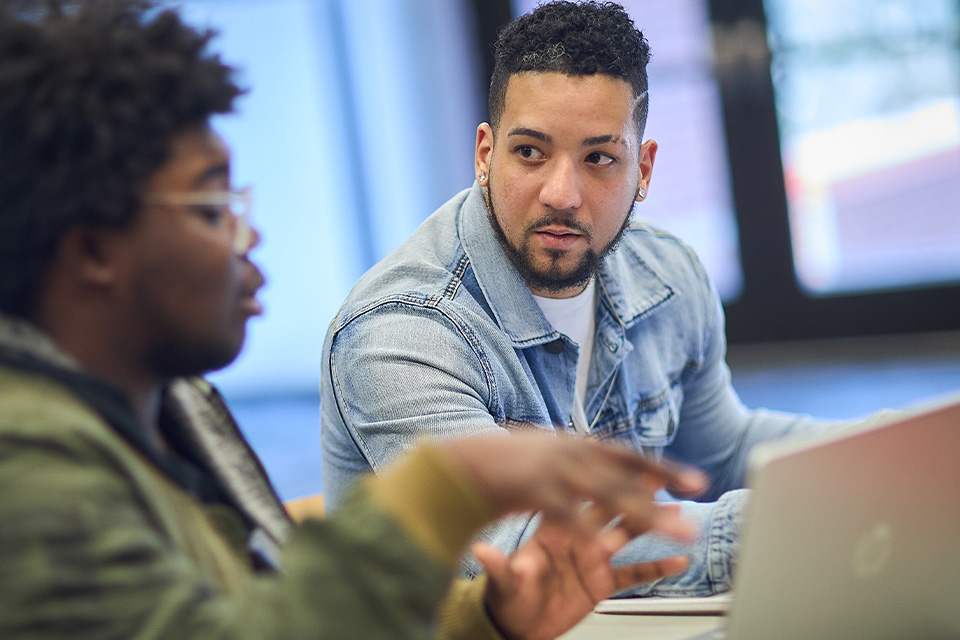 students sitting with laptop