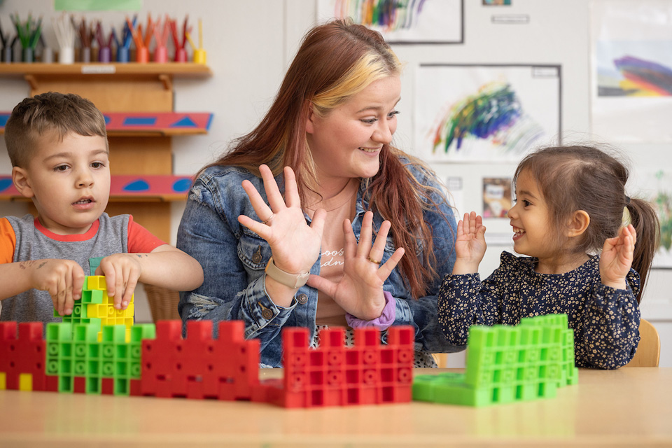 student with children in children's center