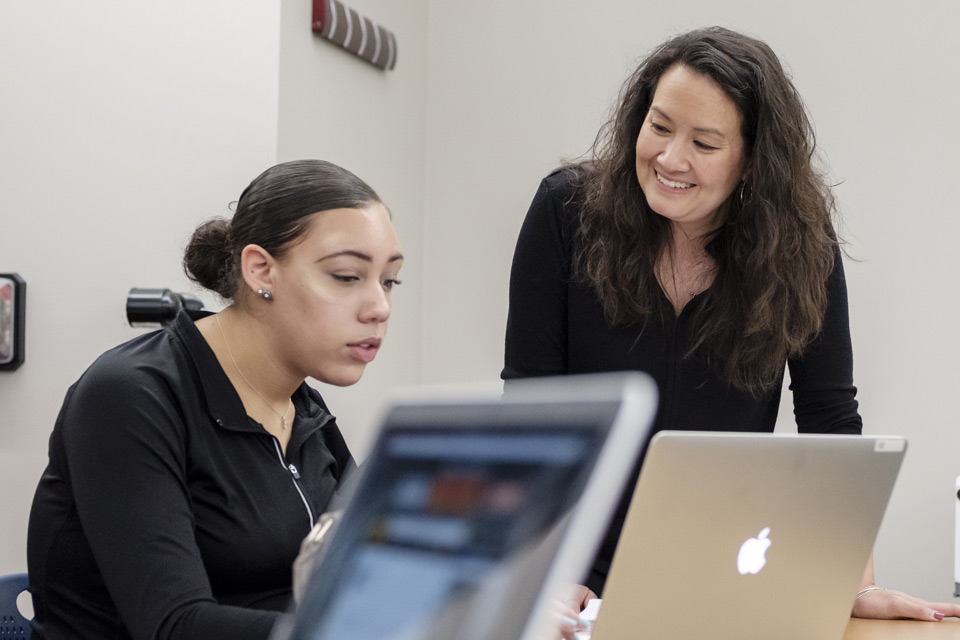 female student being tutored by professor