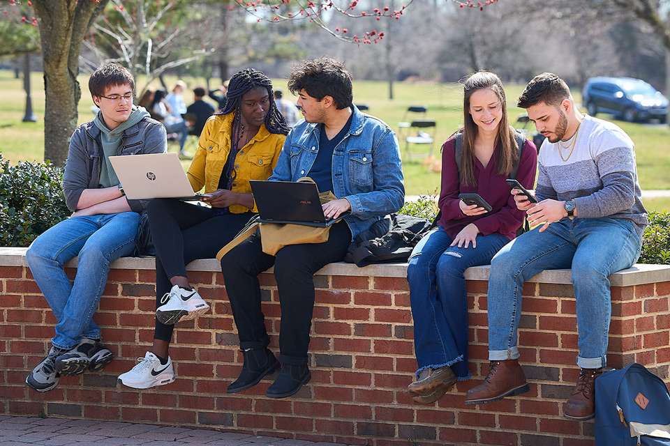 NCC students sitting outside