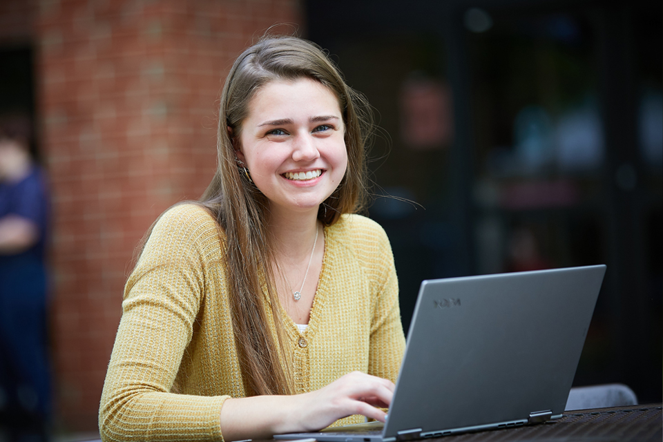 Students looking at laptop