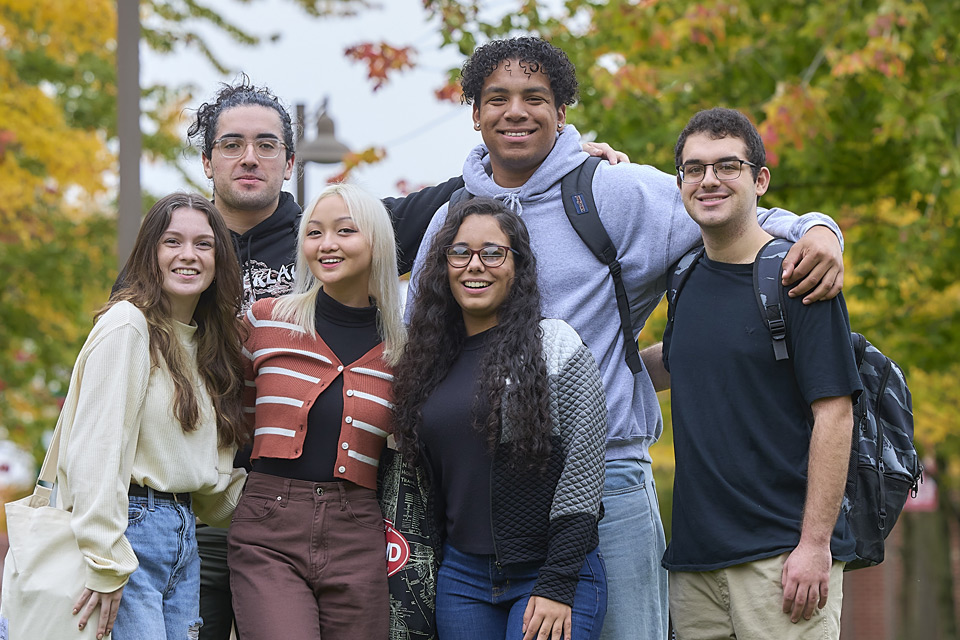 Six diverse students, 3 male, 3 female in a fall background