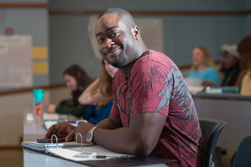 Adult male student sitting in a classroom