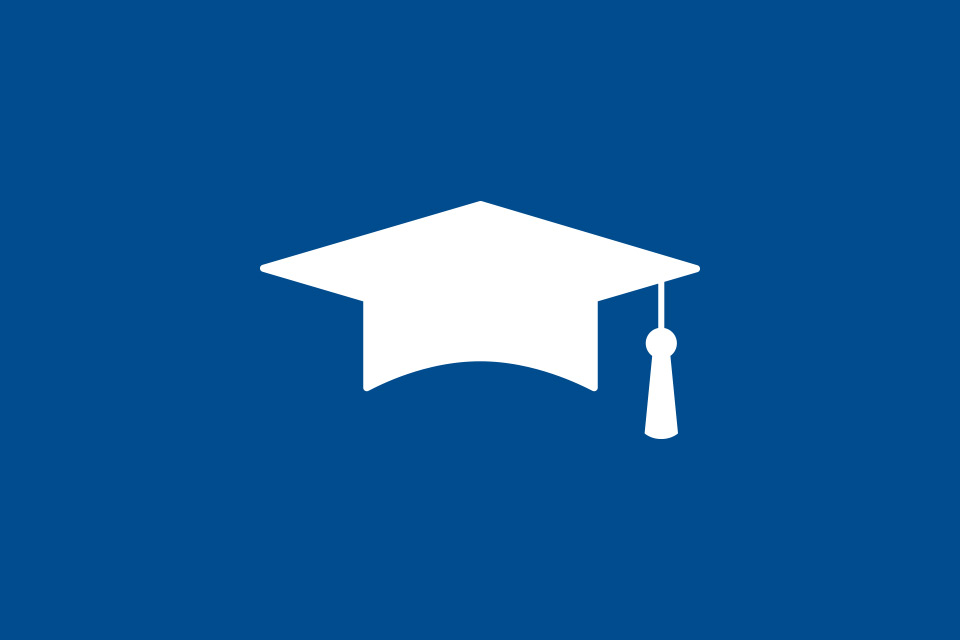 male graduate smiling