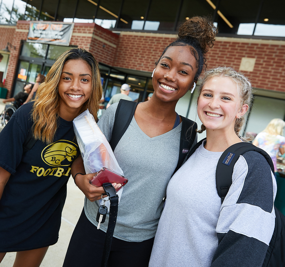 group of students smiling on campus