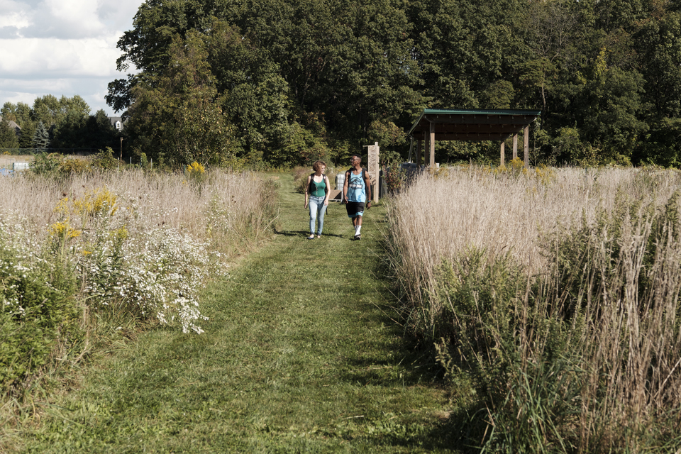 students walking through the east 40 garden