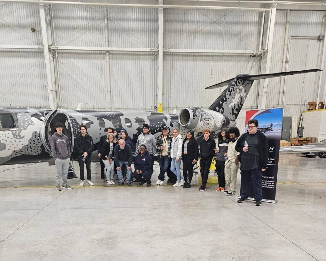 Students with plane at event